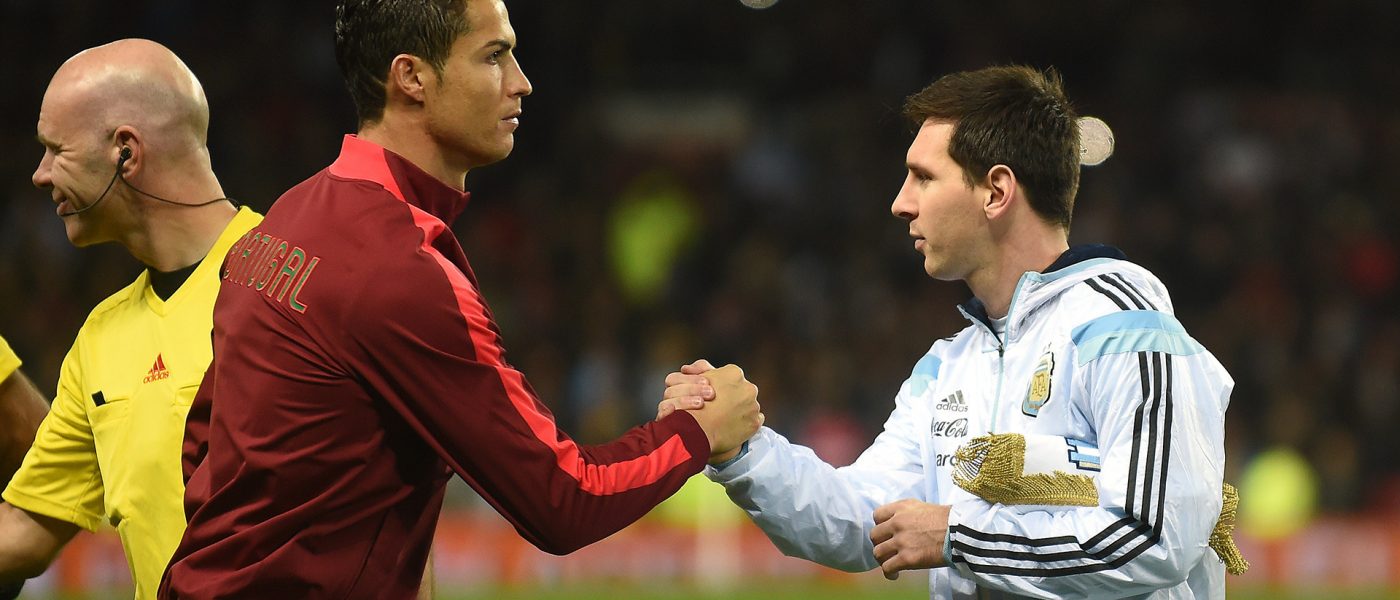 Argentina striker Lionel Messi (R) shakes hands with Portugal's striker Cristiano Ronaldo (L) ahead of kick off of the international friendly football match between the Argentina and Portugal at Old Trafford in Manchester on November 18, 2014. AFP PHOTO / PAUL ELLIS        (Photo credit should read PAUL ELLIS/AFP/Getty Images)